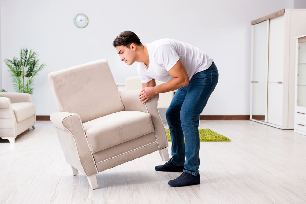 Man Moving Heavy Furniture By Himself
